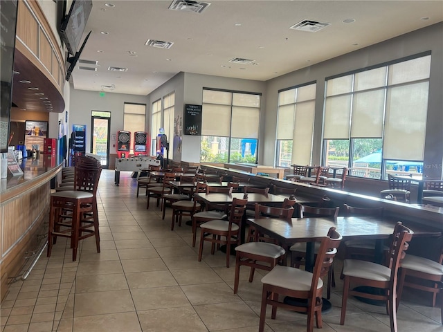 dining space featuring light tile patterned flooring