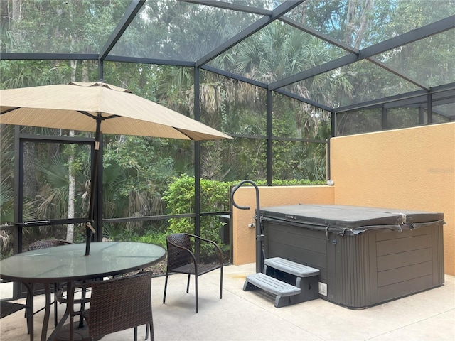 view of patio with a hot tub and a lanai