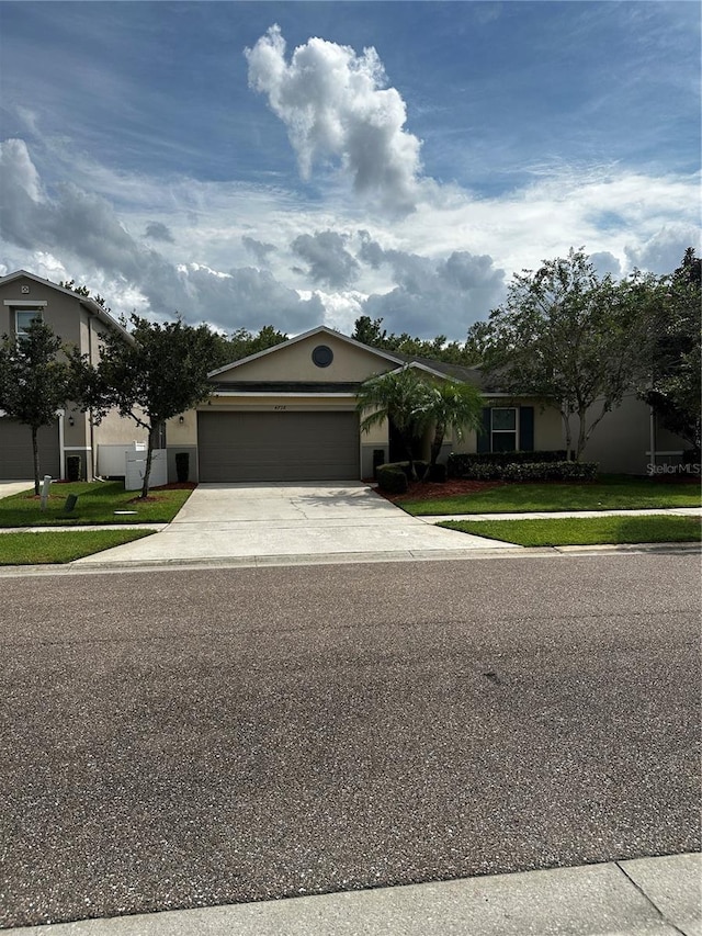 view of front of house with a front yard and a garage