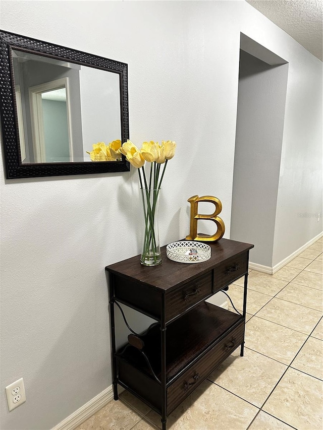 details with tile patterned flooring and a textured ceiling