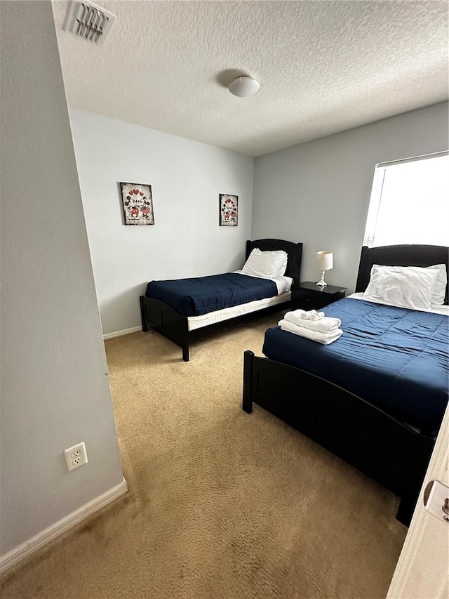 carpeted bedroom with a textured ceiling