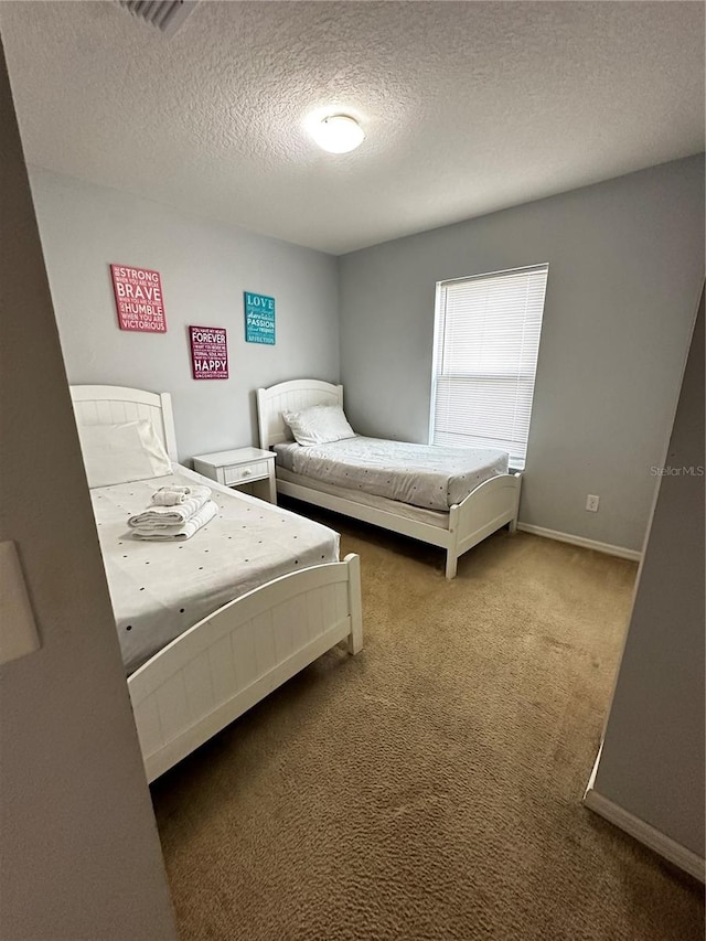 bedroom with a textured ceiling and carpet