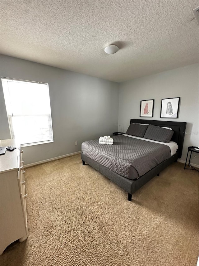 carpeted bedroom with a textured ceiling