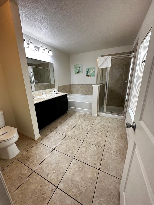 full bathroom with vanity, a textured ceiling, tile patterned flooring, plus walk in shower, and toilet