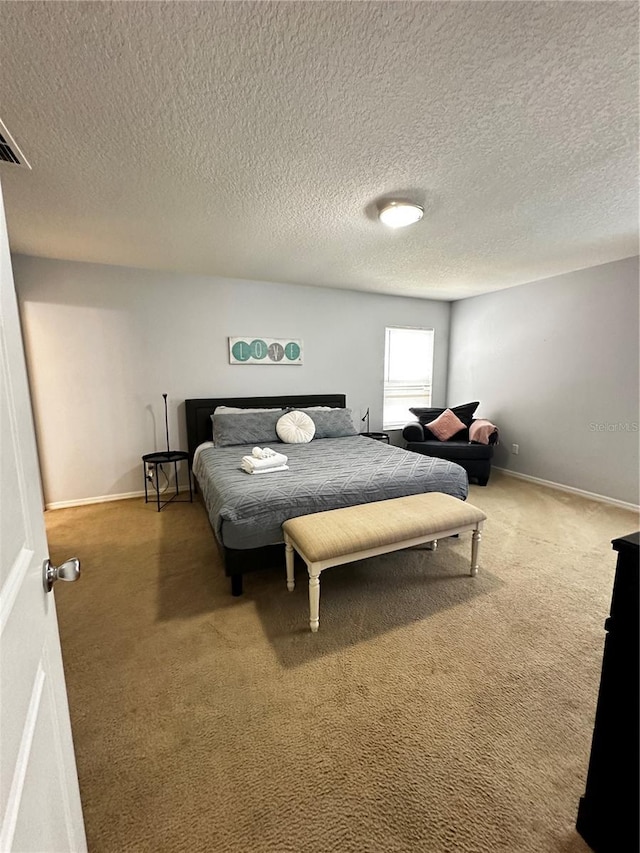 bedroom featuring a textured ceiling and carpet