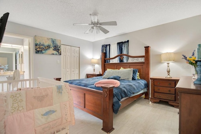 bedroom with a closet, ceiling fan, and a textured ceiling