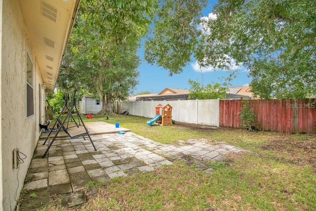 view of yard with a shed and a patio area