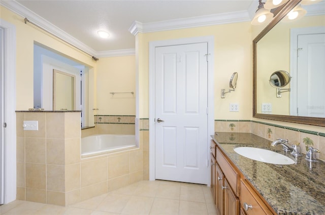 bathroom with tiled tub, vanity, crown molding, and tile patterned flooring