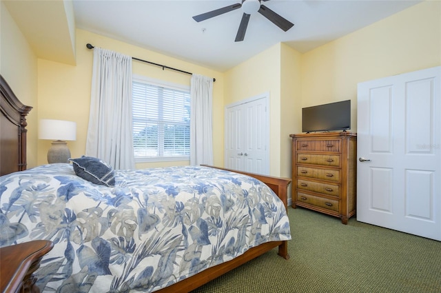 carpeted bedroom featuring ceiling fan and a closet