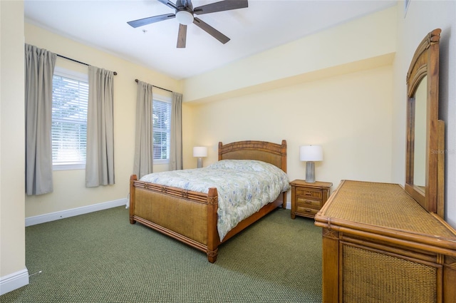 bedroom with dark colored carpet and ceiling fan