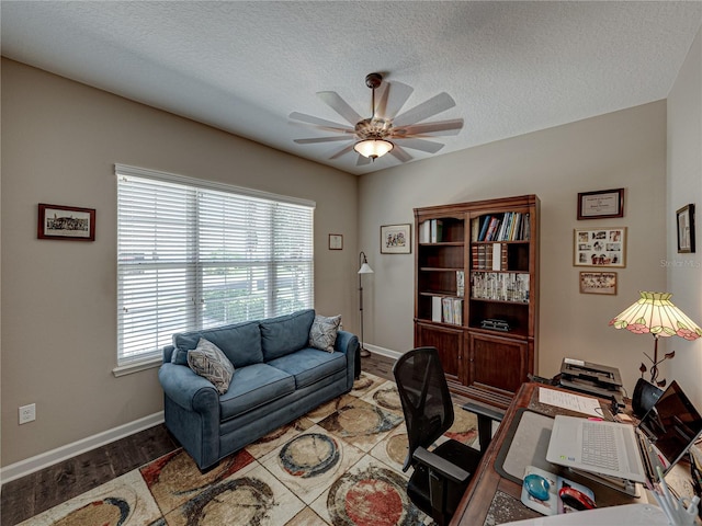 home office featuring ceiling fan, a textured ceiling, and wood-type flooring