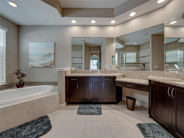 bathroom featuring vanity, shower with separate bathtub, and tile patterned floors