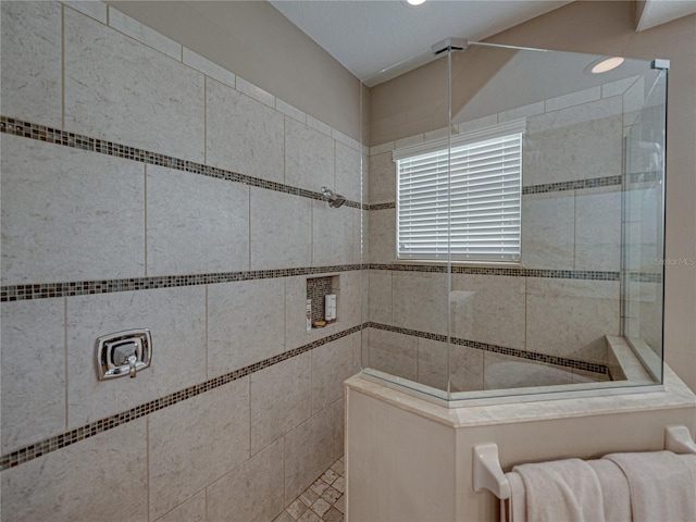 bathroom with tiled shower