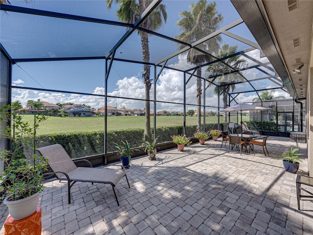 view of patio with glass enclosure