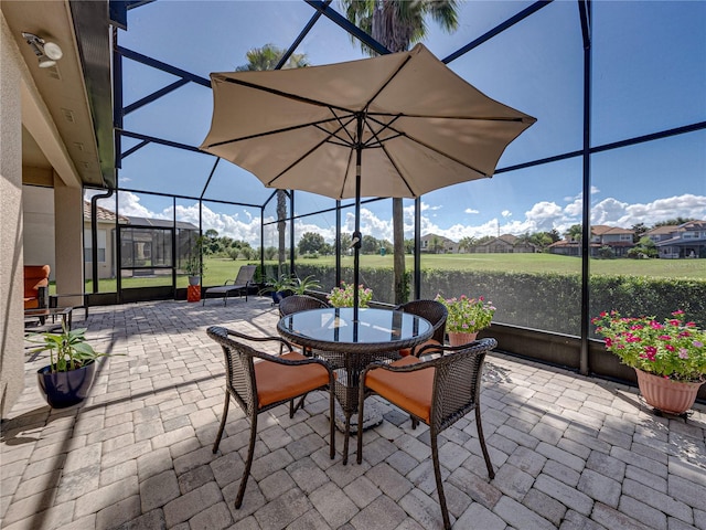 view of patio featuring glass enclosure