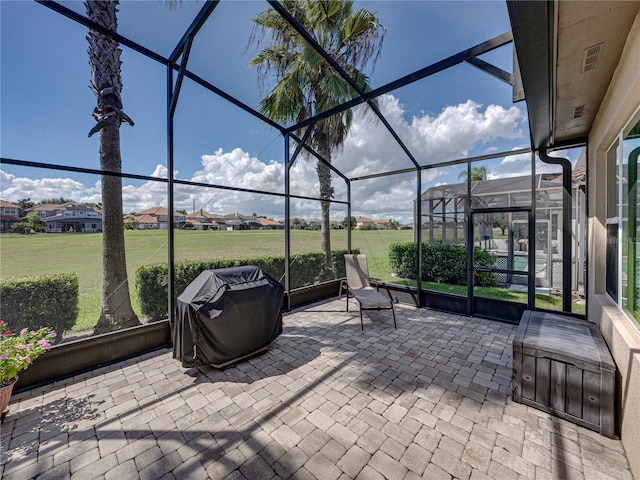 view of patio featuring a grill and a lanai