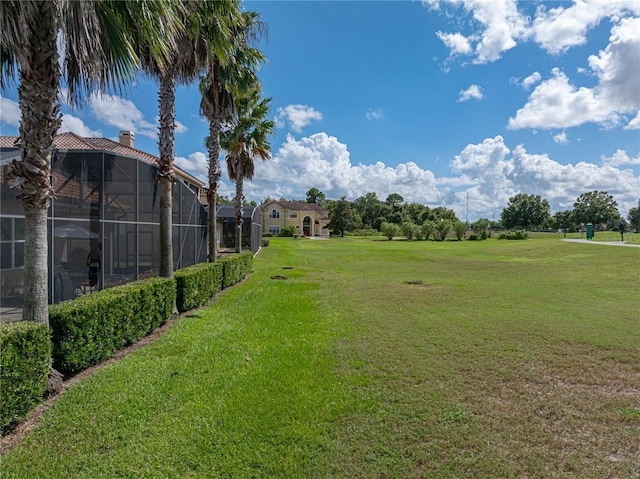 view of yard featuring glass enclosure