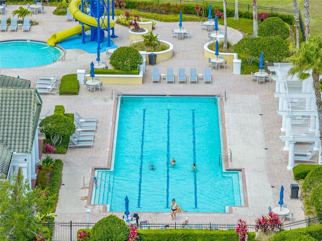 view of swimming pool with a water slide and a patio area