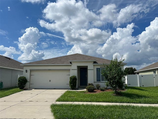 view of front of house with a front yard and a garage