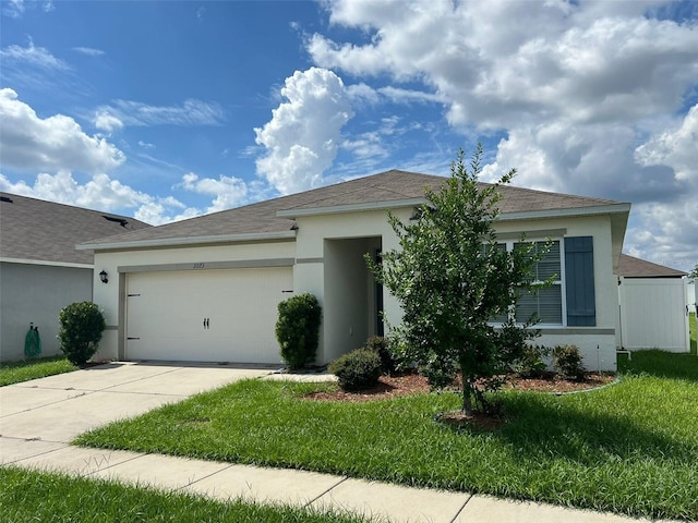 view of front of house featuring a front yard and a garage