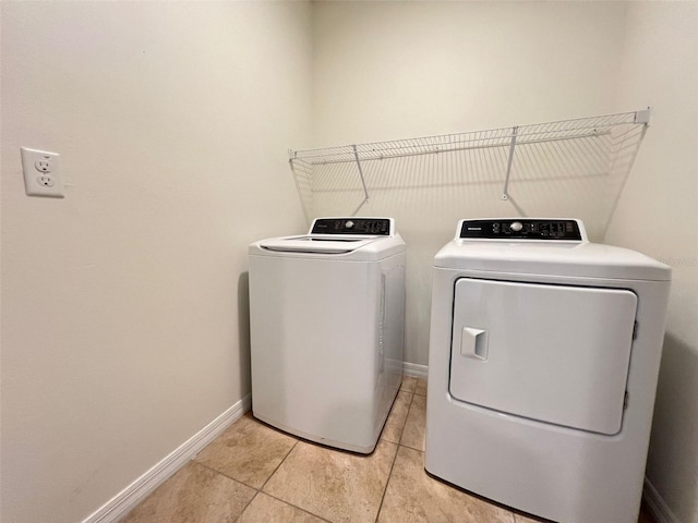 laundry room featuring separate washer and dryer and light tile patterned floors