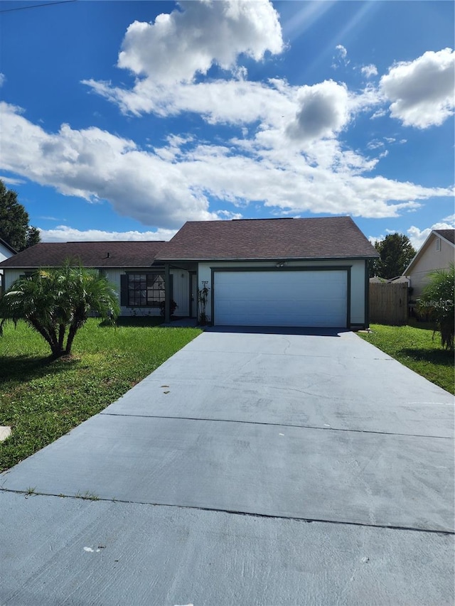 ranch-style home with a front lawn and a garage