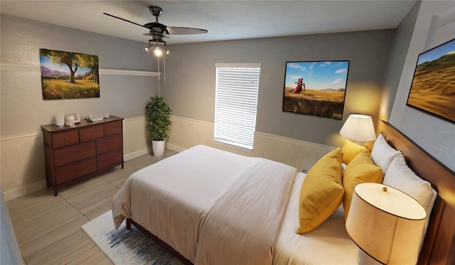 bedroom with ceiling fan and light tile patterned floors