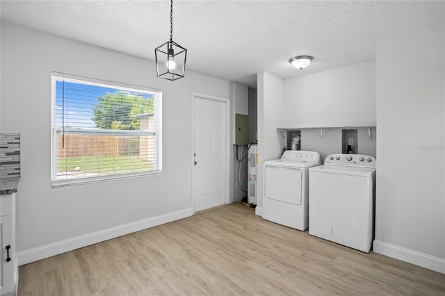 washroom featuring light wood-type flooring, a textured ceiling, and independent washer and dryer