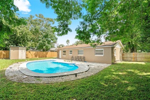 view of swimming pool featuring a shed, a lawn, and a patio area