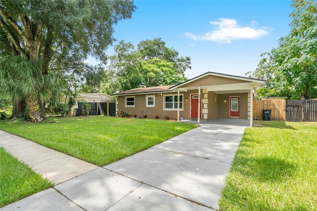 ranch-style house featuring a carport and a front yard