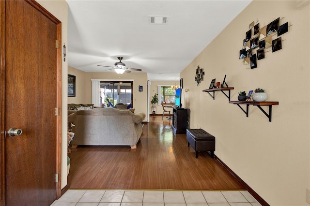 living room featuring light wood-type flooring and ceiling fan