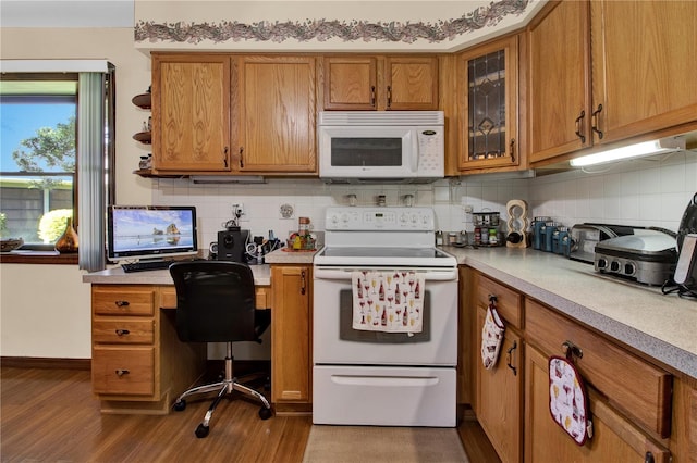 kitchen with decorative backsplash, wood-type flooring, and white appliances