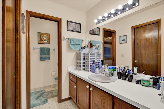 bathroom with vanity, toilet, and tile patterned floors