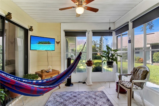 sunroom with a healthy amount of sunlight and ceiling fan