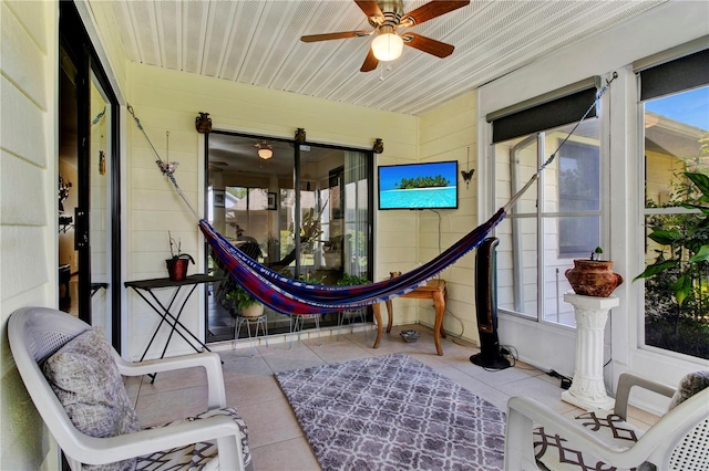 sunroom with ceiling fan and plenty of natural light