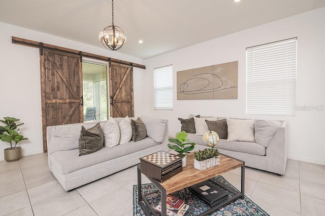 tiled living room featuring a barn door and an inviting chandelier