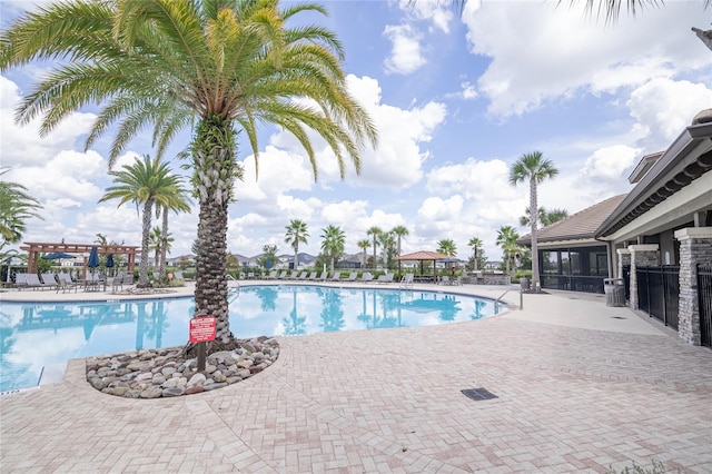 view of pool featuring a sunroom and a patio