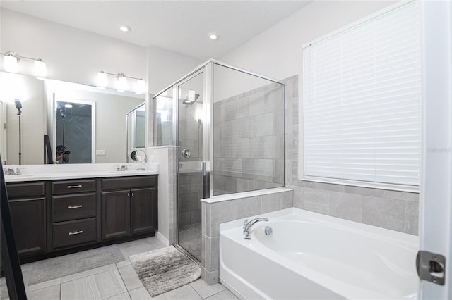 bathroom with shower with separate bathtub, vanity, a textured ceiling, and tile patterned floors