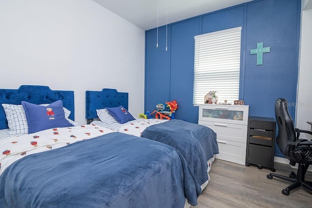 bedroom with hardwood / wood-style floors