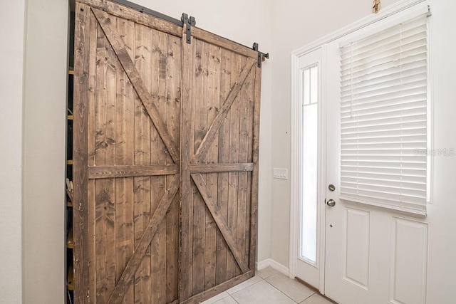 tiled foyer entrance with a barn door