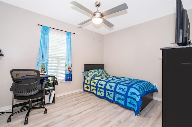 bedroom with ceiling fan and light hardwood / wood-style flooring