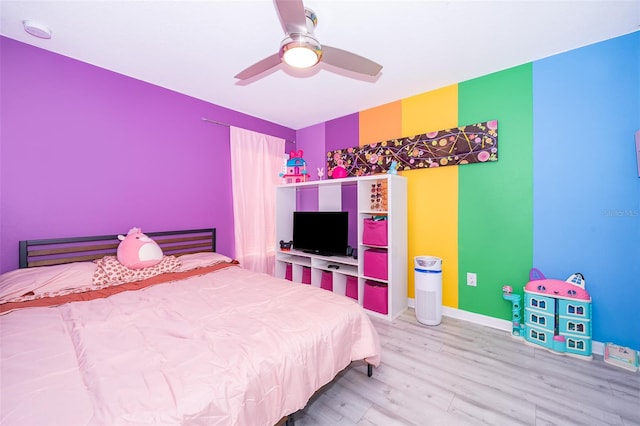 unfurnished bedroom with ceiling fan and hardwood / wood-style flooring