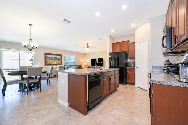 kitchen with pendant lighting, ceiling fan with notable chandelier, a healthy amount of sunlight, and black appliances