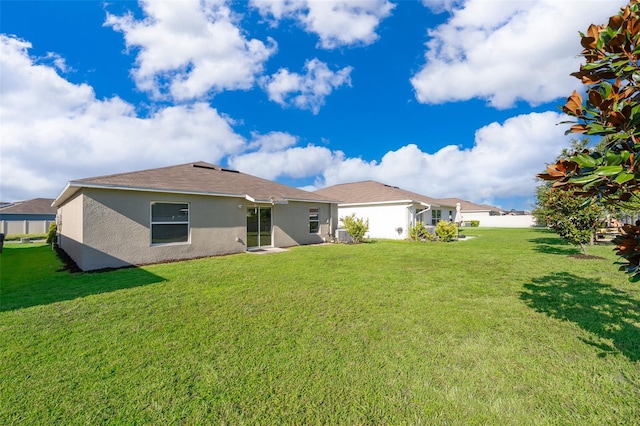 back of property featuring a lawn