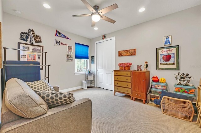 living area with carpet flooring and ceiling fan