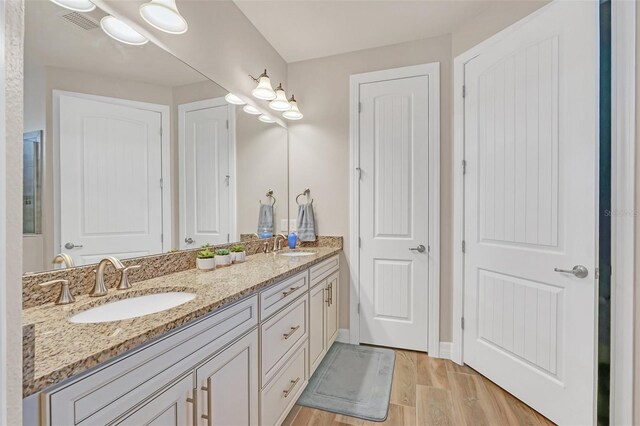 bathroom with hardwood / wood-style flooring and vanity