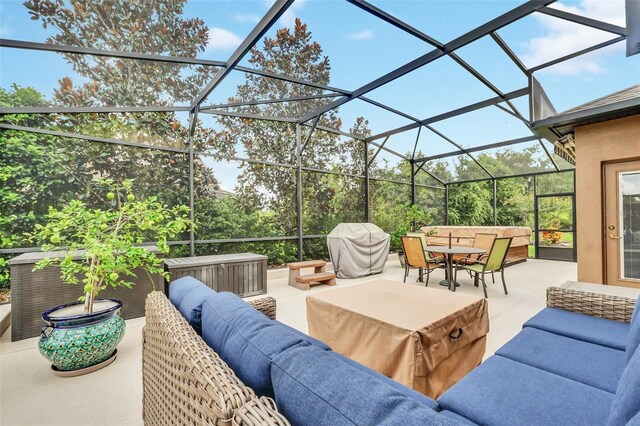 view of patio / terrace featuring glass enclosure and an outdoor living space