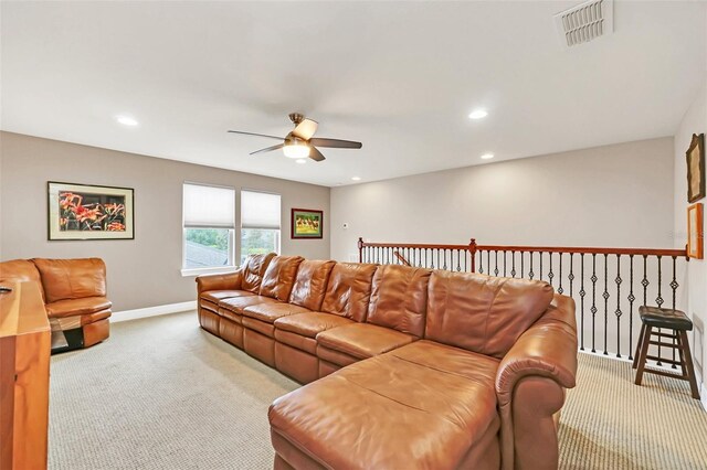 living room with ceiling fan and light colored carpet