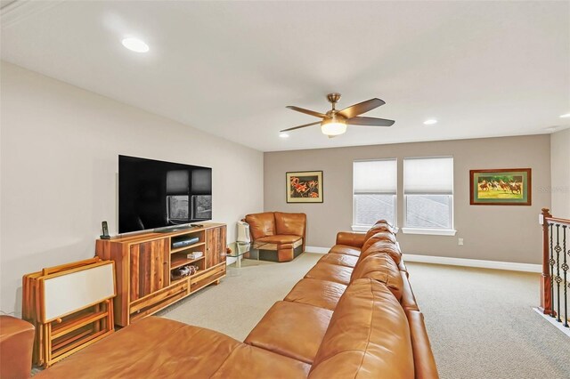 carpeted living room featuring ceiling fan