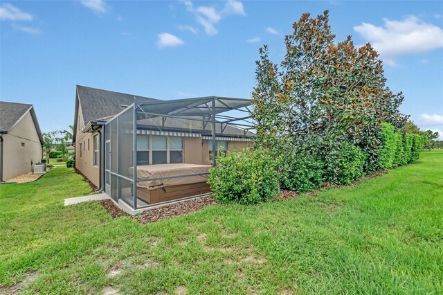 exterior space with a lawn and glass enclosure